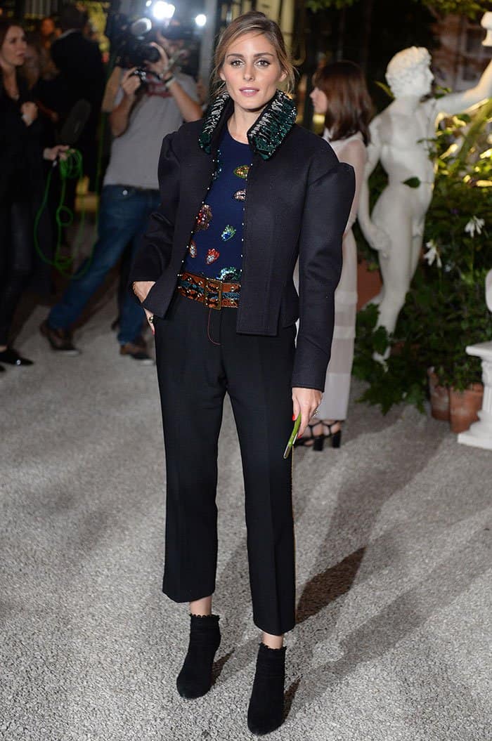 Olivia Palermo chose a navy top shimmering with sequins and matched it with cropped trousers, uniquely accented with a yellow snakeskin side-stripe