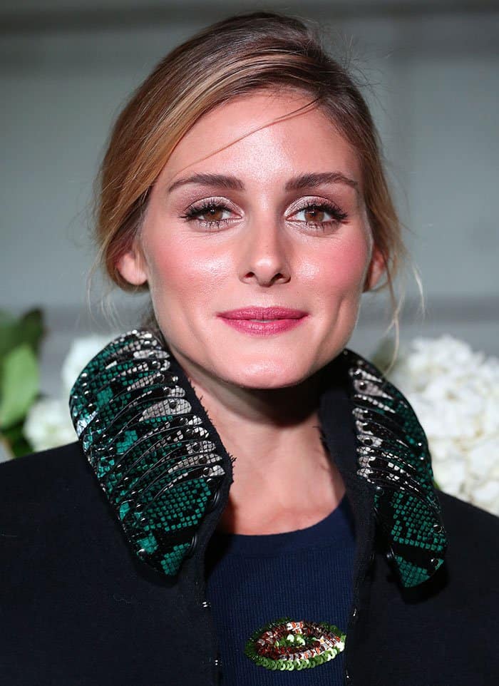 Complementing her striking attire, Olivia Palermo kept her beauty look understated, gathering her blonde hair into a relaxed ponytail and choosing a soft makeup palette highlighted by pink lipstick and blush