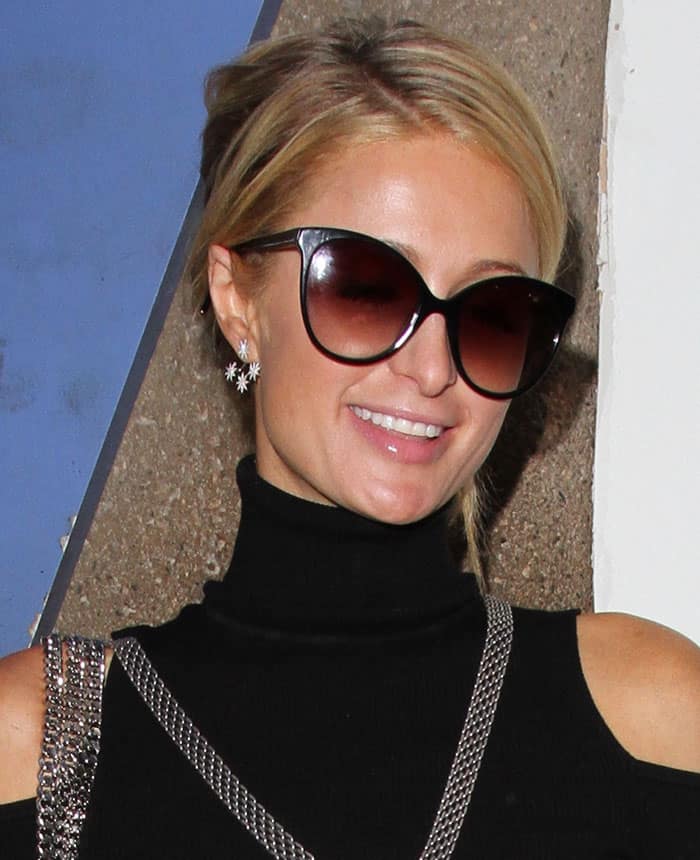 Shielding her gaze, Paris Hilton donned a pair of Sunday Somewhere sunglasses