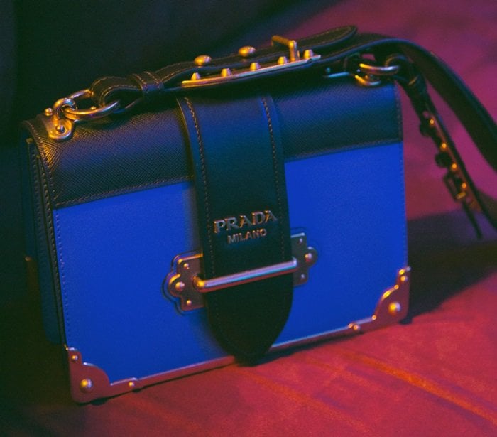 Blending vintage glamour with contemporary design, Prada's iconic Cahier shoulder bag takes inspiration from ancient trunks and antique books with its burnished gold-toned hardware, protective corners and elegantly structured shape