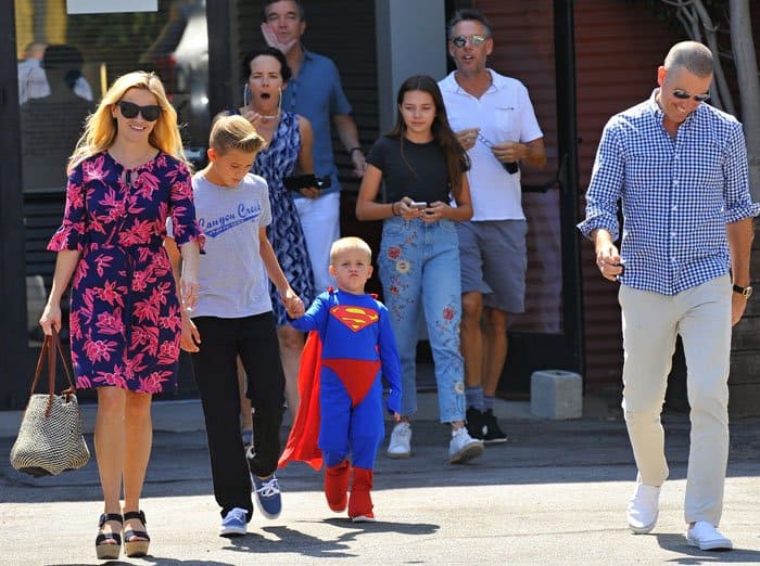 Reese Witherspoon looks colorful in a Draper James dress as she leaves church with her family