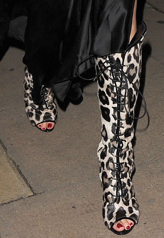 Rita Ora shows off her toes in leopard-print knee-high boots with leather trims and four-inch heels