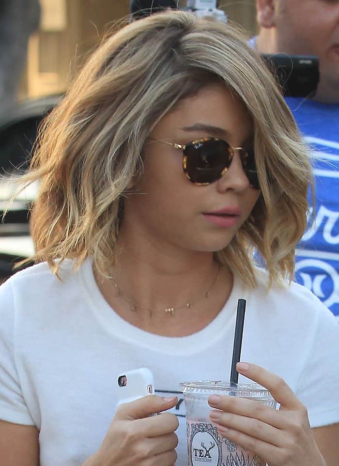 Sarah Hyland carries a drink from Alfred Tea Roo, a teahouse chain known for its signature millennial pink design and its accessible hand-selected premium teas