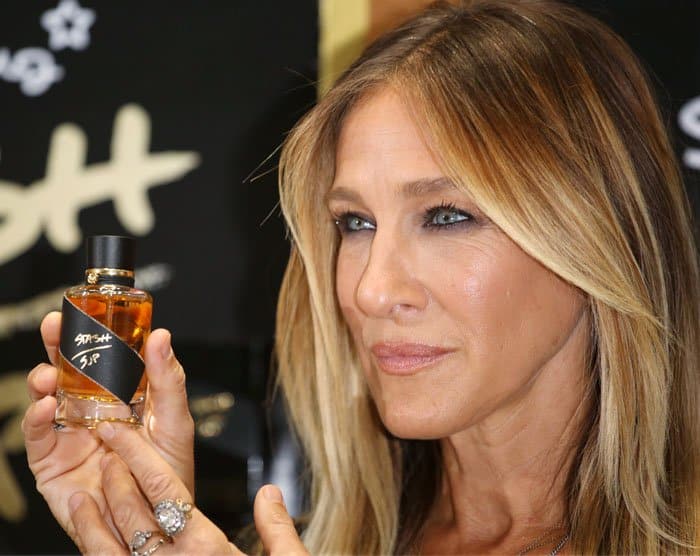 Sarah Jessica Parker shows off a bottle of her latest fragrance "Stash"