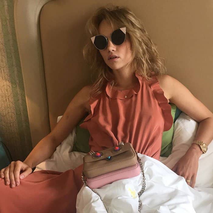 Suki uploads a photo of her in bed with the caption, "Cat eyed cat napping in @fendi #fendilei"