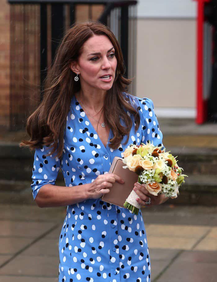 Kate Middleton's dress, peppered with contrasting black and white polka dots, is tailored to accentuate her silhouette