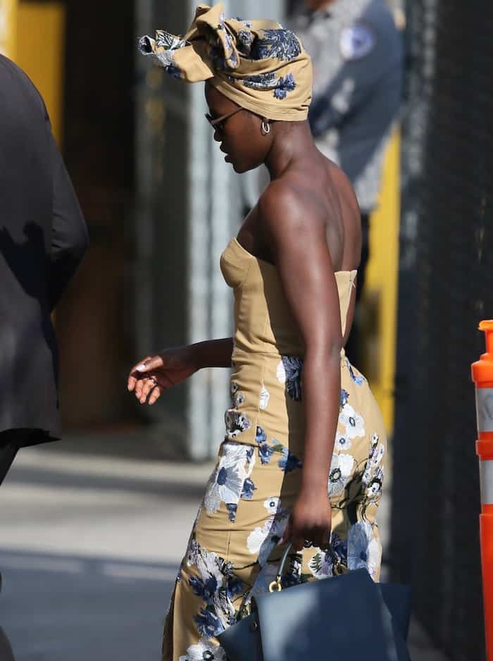 Lupita Nyong'o dazzled in a bespoke floral Erdem dress, accentuated with coordinating headwear tailored just for her