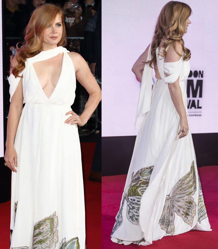 Amy Adams graced the red carpet in a Valentino Spring 2016 Couture white halter gown featuring a draped, cut-out shoulder detail, a deep V-neckline, and a printed hem