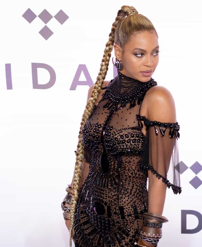Beyoncé strikes a pose, showcasing her sleek, long braided ponytail