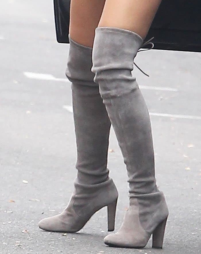 Cara Santana elevates her stature and style with the iconic Stuart Weitzman “Highland” boots, blending sophistication with a touch of allure