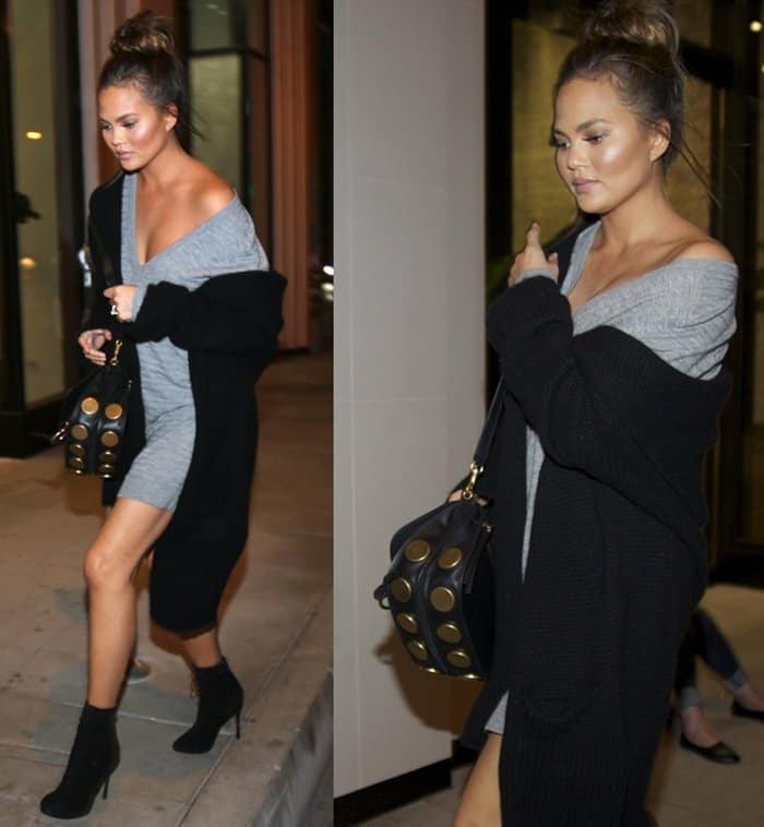 Chrissy Teigen steps out in sleek black sock booties, effortlessly elevating her cozy gray mini dress and oversized cardigan with model-off-duty flair