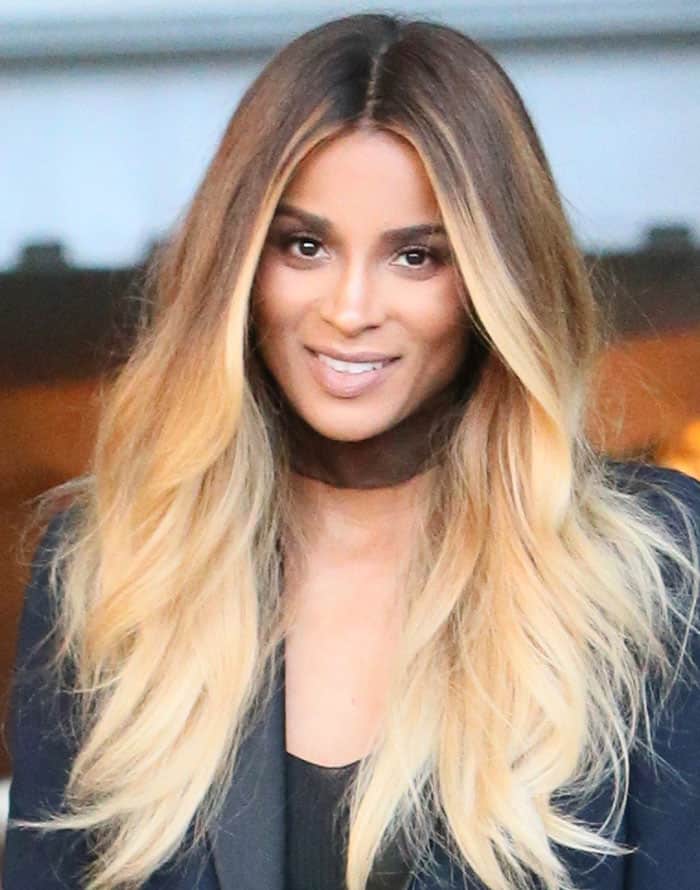 Ciara flaunts her sultry look with cascading ombre tresses and a makeup palette of smoky eyes and nude lipstick, radiating elegance and confidence