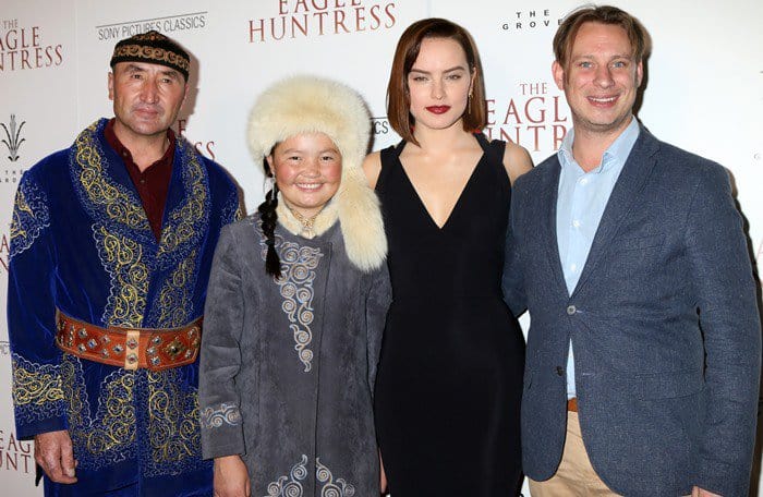 Daisy Ridley posing with director Otto Bell and subjects of the documentary film Nurgaiv Rys and Aisholpan Nurgaiv