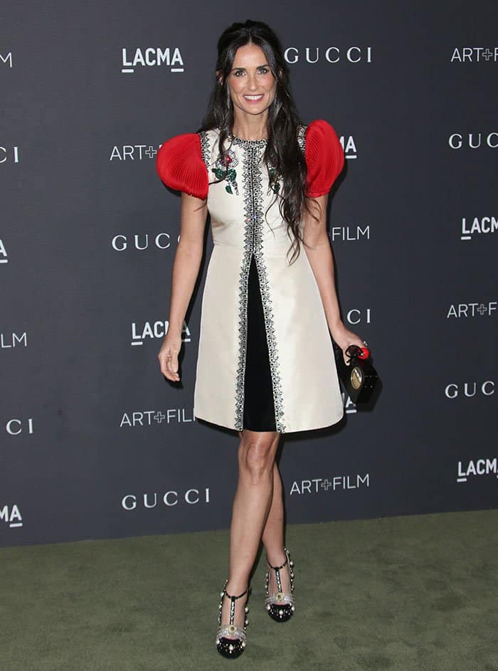 Demi Moore rocks a Gucci Spring 2017 dress featuring red plissé sleeves