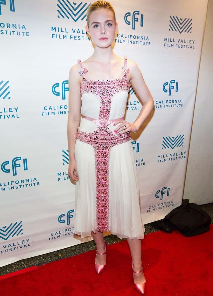 Elle Fanning took on the persona of Elle Woods, the iconic character from the movie "Legally Blonde," portrayed by Reese Witherspoon, as she dressed head-to-toe in a vibrant shade of rose pink