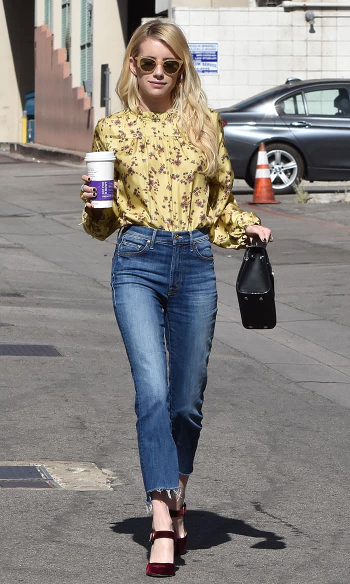 Emma Roberts steps out in Beverly Hills on October 19, 2016, wearing a Wilfred for Aritzia blouse, Mother frayed jeans, Paul Andrew velvet heels, Garrett Leight sunglasses, and a Dior Mini Diorever bag