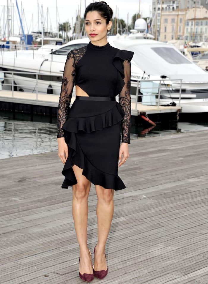 Freida Pinto stuns in a black ruffled Self-Portrait dress paired with plum Rupert Sanderson pumps at the 2016 MIPCOM photocall in Cannes