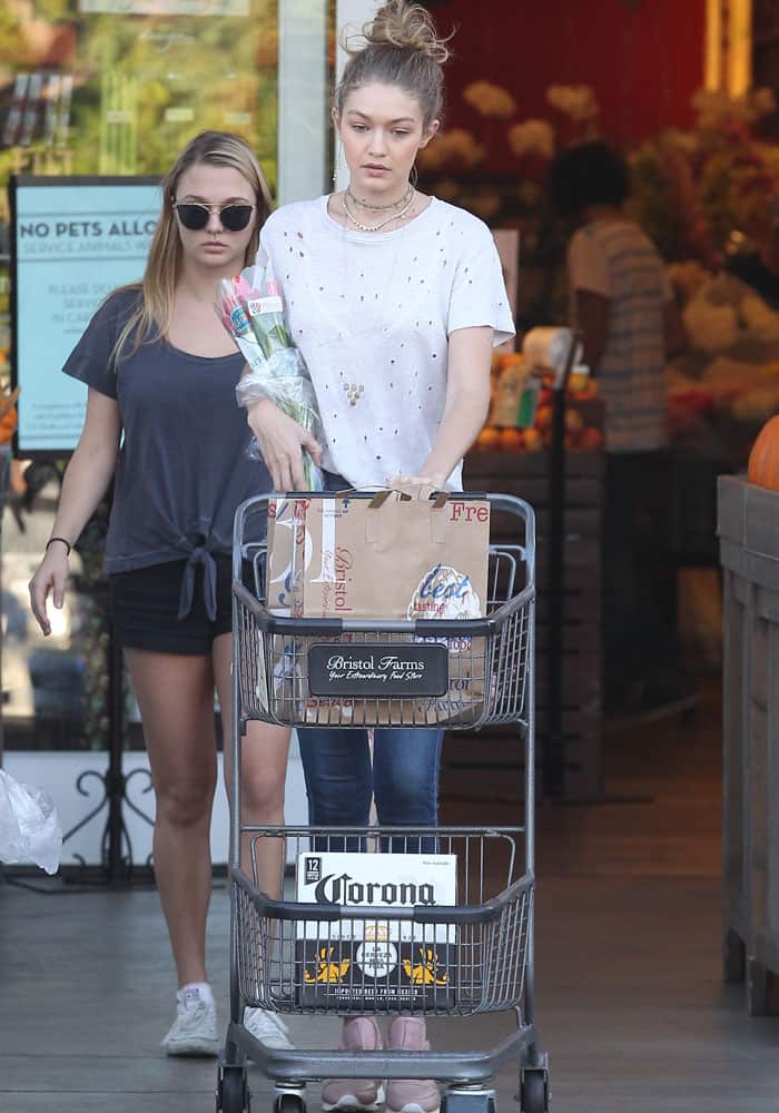 Gigi Hadid sported an IRO "Clay" perforated shirt paired with AGOLDE "Sophie" skinny jeans in the shade Soleil