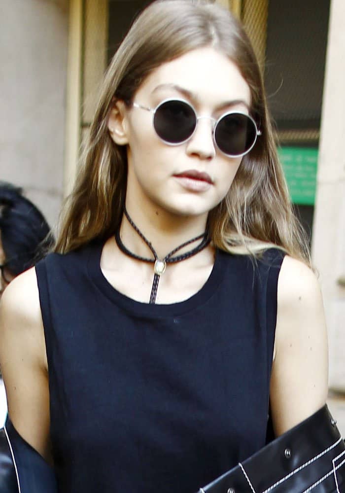 Gigi Hadid was seen leaving a fashion show in Paris, France, during Paris Fashion Week on October 3, 2016, wearing a black muscle shirt by Re/Done