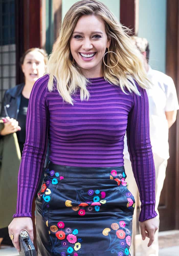 Hilary Duff adorned herself in a chic ensemble, featuring a striped top paired with a floral leather "Aneta" skirt by Tanya Taylor
