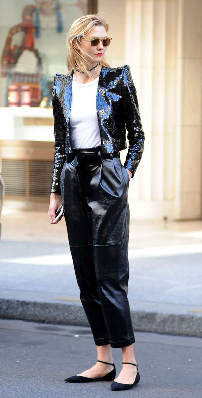 Karlie Kloss exudes effortless chic in glossy cropped pants, a sequined Saint Laurent jacket, and Jimmy Choo flats during Paris Fashion Week