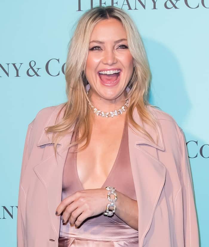 Kate Hudson radiates joy in a blush-toned ensemble, accessorized with dazzling Tiffany & Co. jewelry at the Beverly Hills store celebration