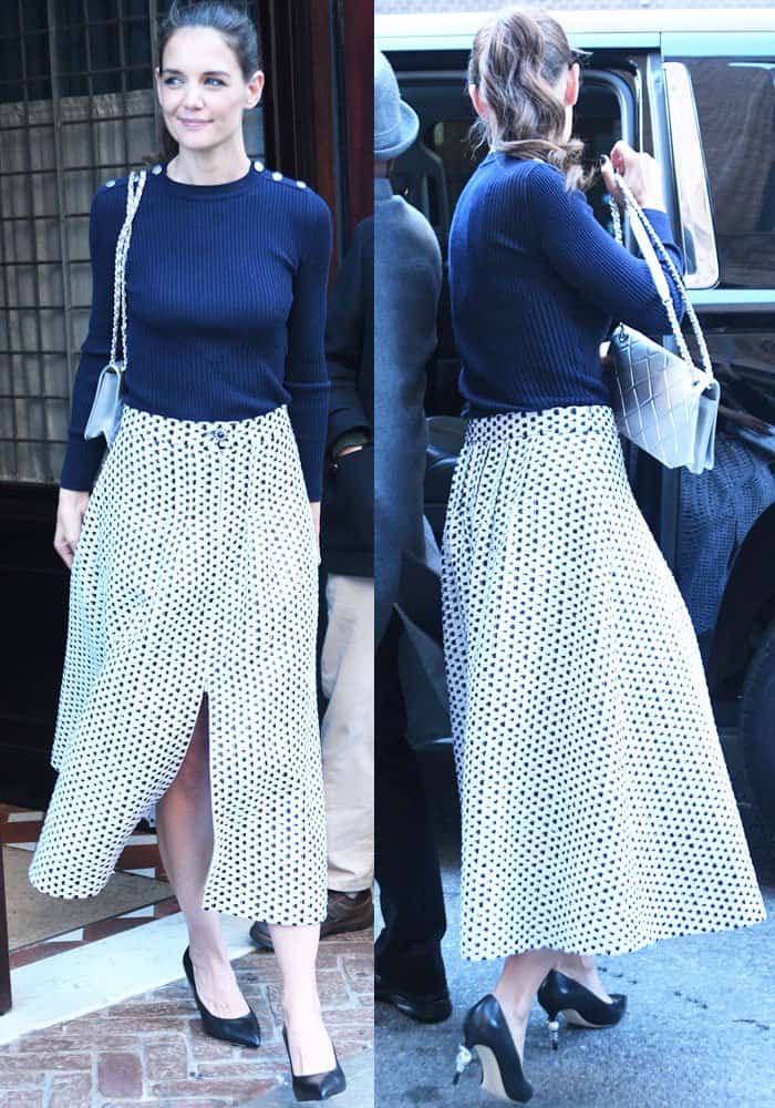 Katie styled a navy blue top with a front-slit skirt, a stunning pair of pearl pumps, and a silver quilted bag