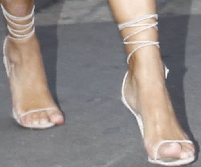 Not exactly running shoes: Kim narrowly escapes the prankster in a pair of skimpy Manolo Blahnik heels