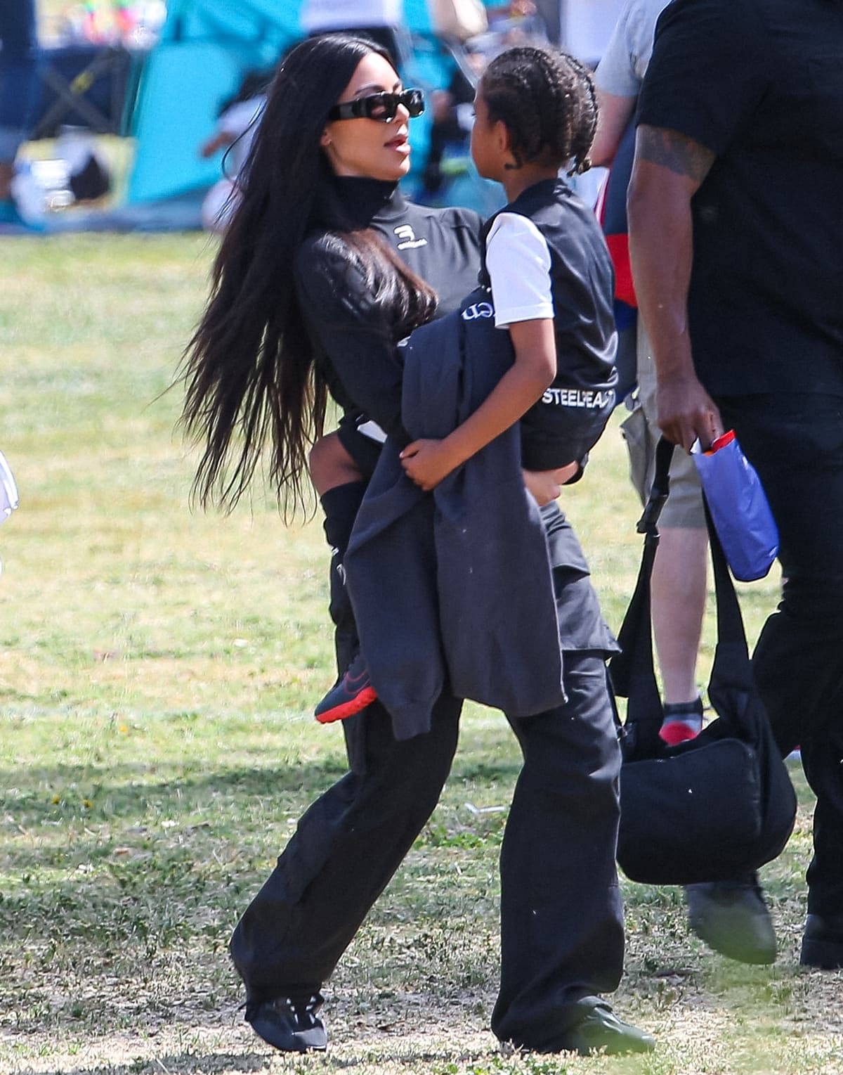 Kim Kardashian in Balenciaga carries her 6-year-old son Saint West
