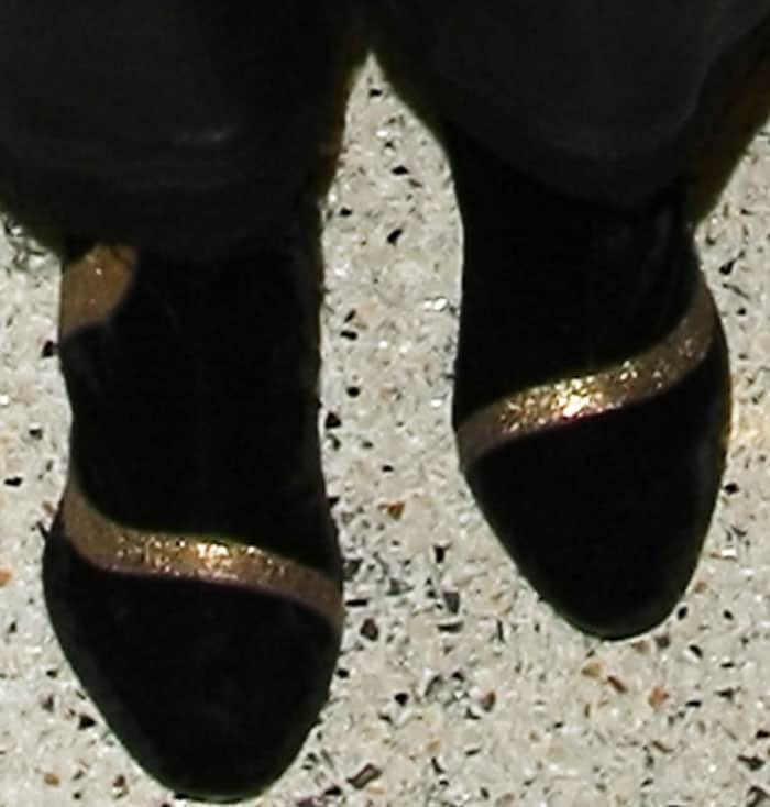 Kourtney Kardashian sported a quirky pair of Dries Van Noten velvet boots en route to Paris