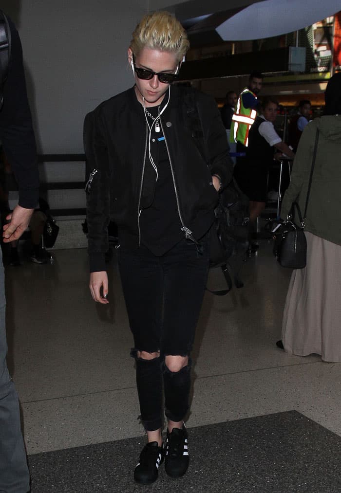 Kristen Stewart sported a Local Authority sweatshirt paired with a Saint Laurent bomber jacket, embellished with zippered and snap-buttoned pockets