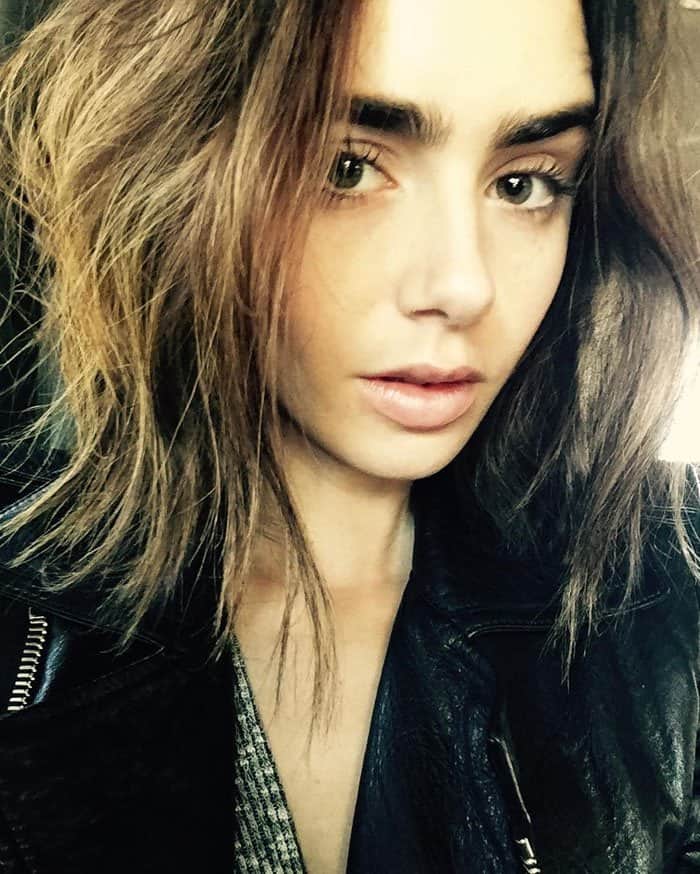 Lily Collins leaves for Paris in seemingly the same outfit she left the city in