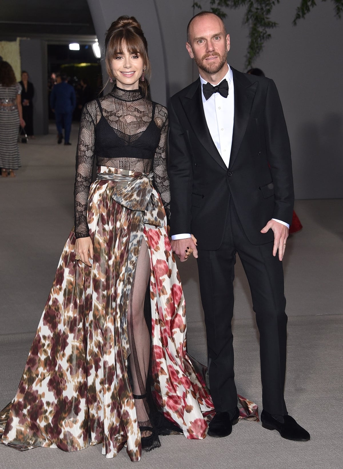 Lily Collins, accompanied by her husband Charlie McDowell, showcased an elegant Dior silk skirt ensemble at the 2022 Academy Museum Gala in Los Angeles