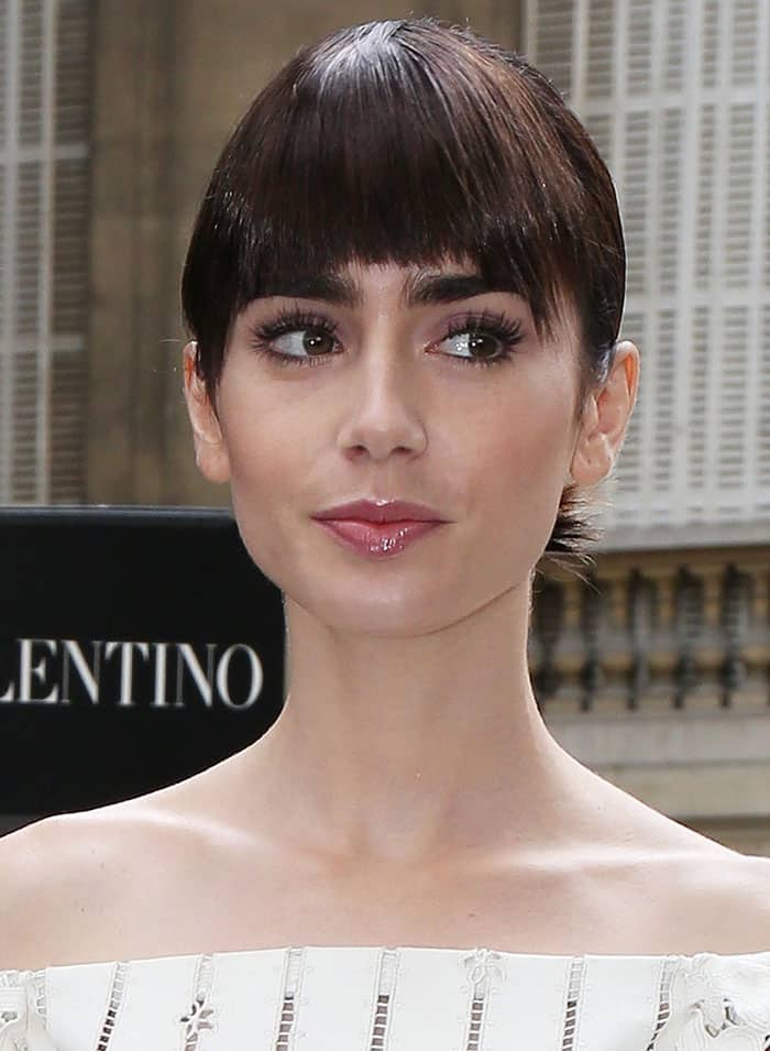 Lily Collins pulled her hair back into a chic updo with a fringe cut just right above her signature eyebrows