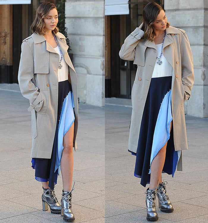 Miranda Kerr stuns in a beige trench coat paired with a patchwork-style skirt and silver metallic ankle boots for a chic photoshoot at Place Vendome during Paris Fashion Week