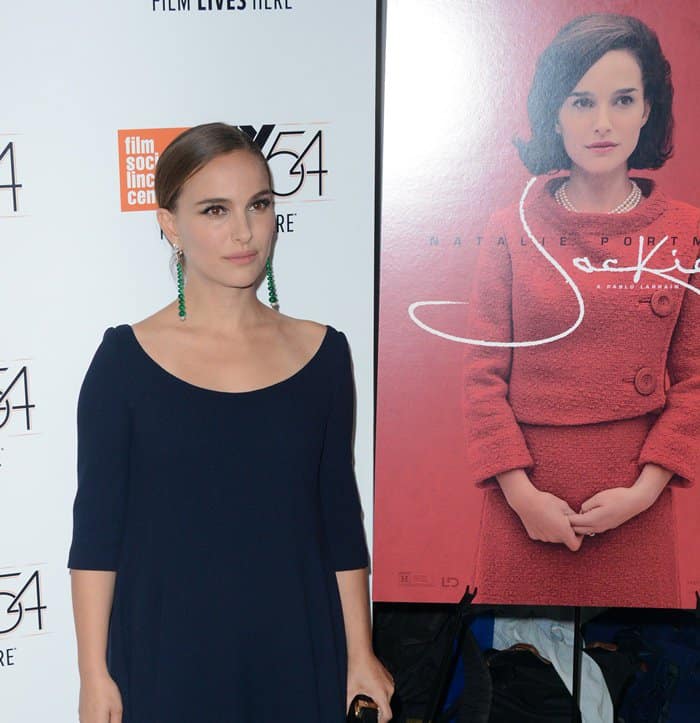 Natalie Portman poses elegantly in front of the Jackie poster at the New York Film Festival