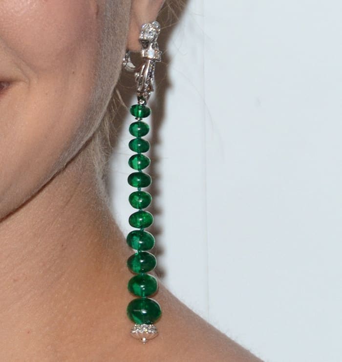 Natalie Portman's earrings feature a stunning vertical arrangement of polished emerald beads, elegantly suspended from a diamond-encrusted clasp by Van Cleef & Arpels