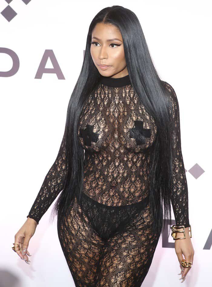 Nicki Minaj confidently flaunts her figure in a sheer lace bodysuit, accessorized with bold pasties and black underwear