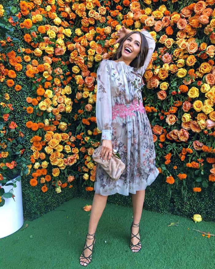 Insta-Perfect: Olivia Culpo plays the 'wallflower' against a vibrant floral backdrop, sharing a playful moment from the Veuve Clicquot Polo Classic on her Instagram