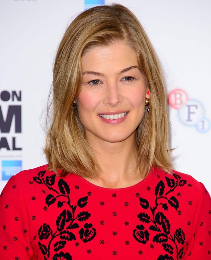 Rosamund Pike's blonde hair, worn loose, framed a face that was given a subtle makeup touch