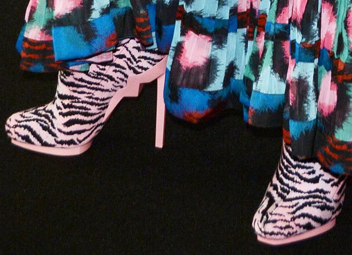 Rosario Dawson wears a quirky pair of tiger print boots from the Kenzo x H&M collaboration line