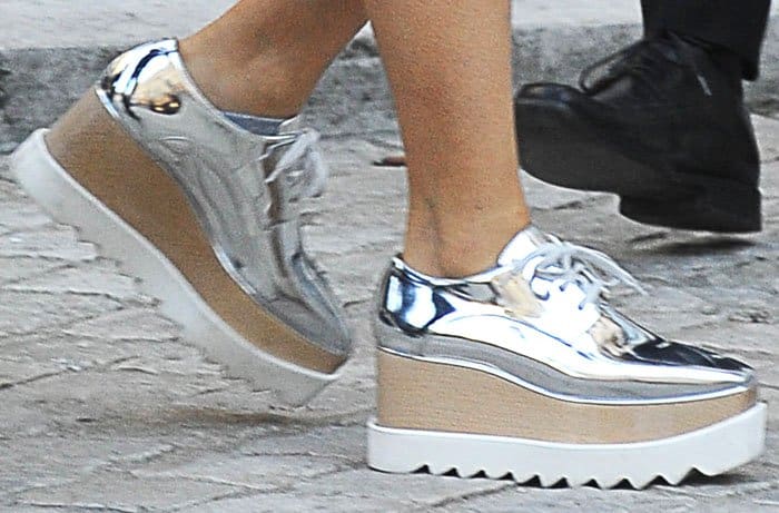 Salma Hayek wears the "Elyse" wedge sneakers in silver by Stella McCartney