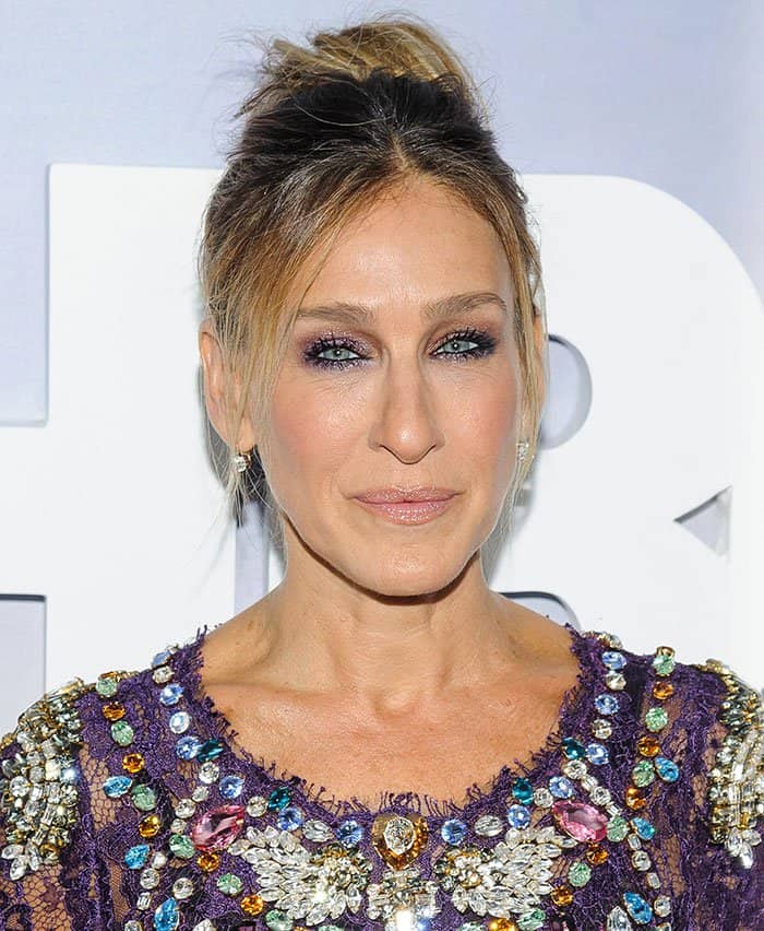 Sarah Jessica Parker''s chic updo and shimmering purple eyeshadow harmoniously complemented her attire