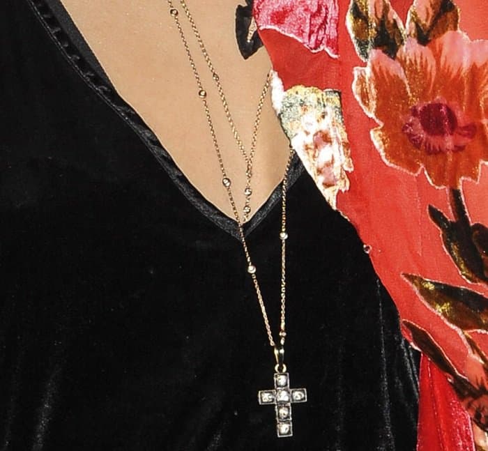 Vanessa Hudgens layers her look with a striking cross pendant necklace
