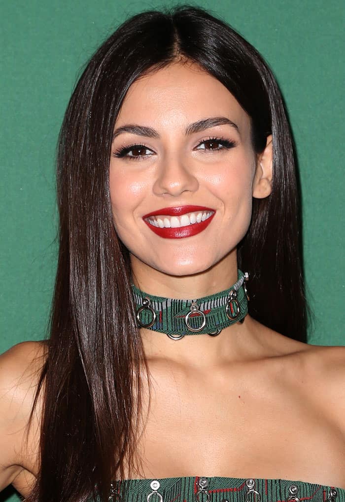 Victoria Justice's sleek, straight hair and vibrant red lipstick added a pop of color and enhanced her overall look