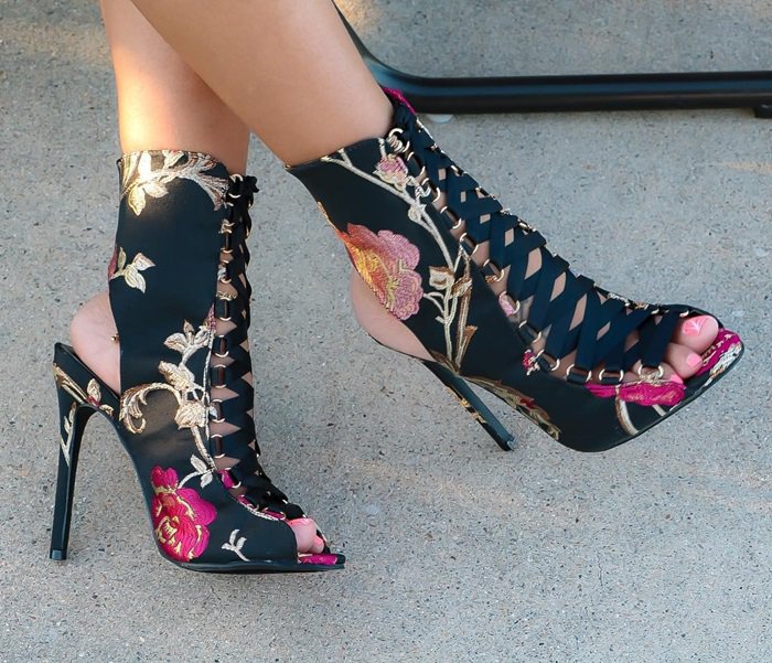 These gorgeous heels feature a satin upper with a floral brocade design throughout, peep toe silhouette, lace-up front design, and wrapped stiletto heel