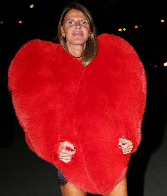 Anna Dello Russo wears a striking $15,550 heart-shaped red fox fur cape from Yves Saint Laurent