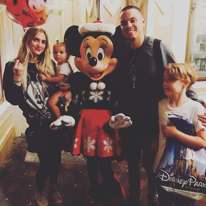 Ashlee Simpson and Evan Ross enjoy a magical day at Disneyland with their children, posing alongside Minnie Mouse for a festive family photo