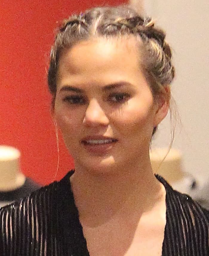 Chrissy Teigen wore her hair back in chic braids and sported minimal makeup