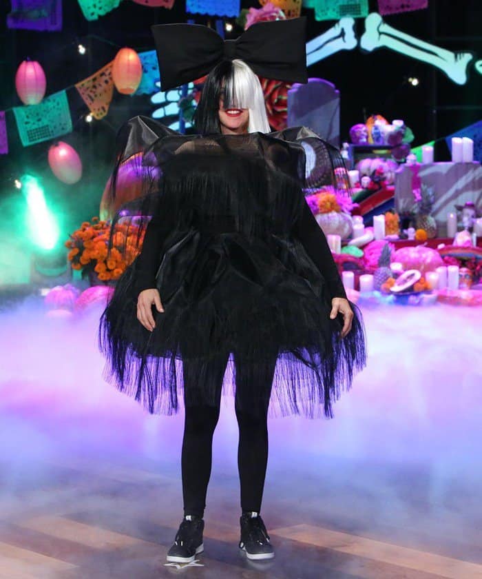 Ellen DeGeneres channels Sia's signature style, complete with an oversized wig, for her Halloween show